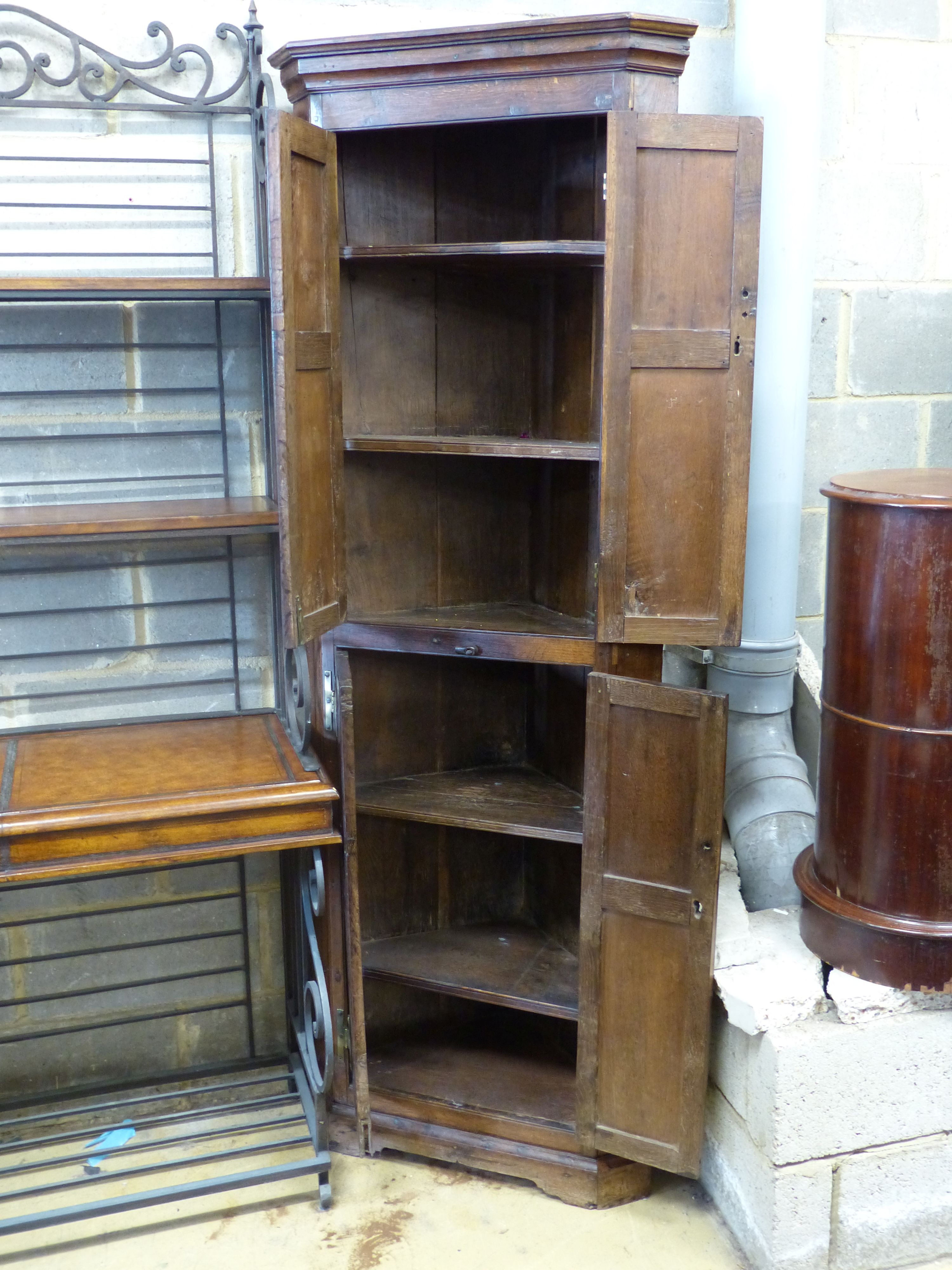 A George III oak standing corner cabinet, width 70cm depth 36cm height 195cm